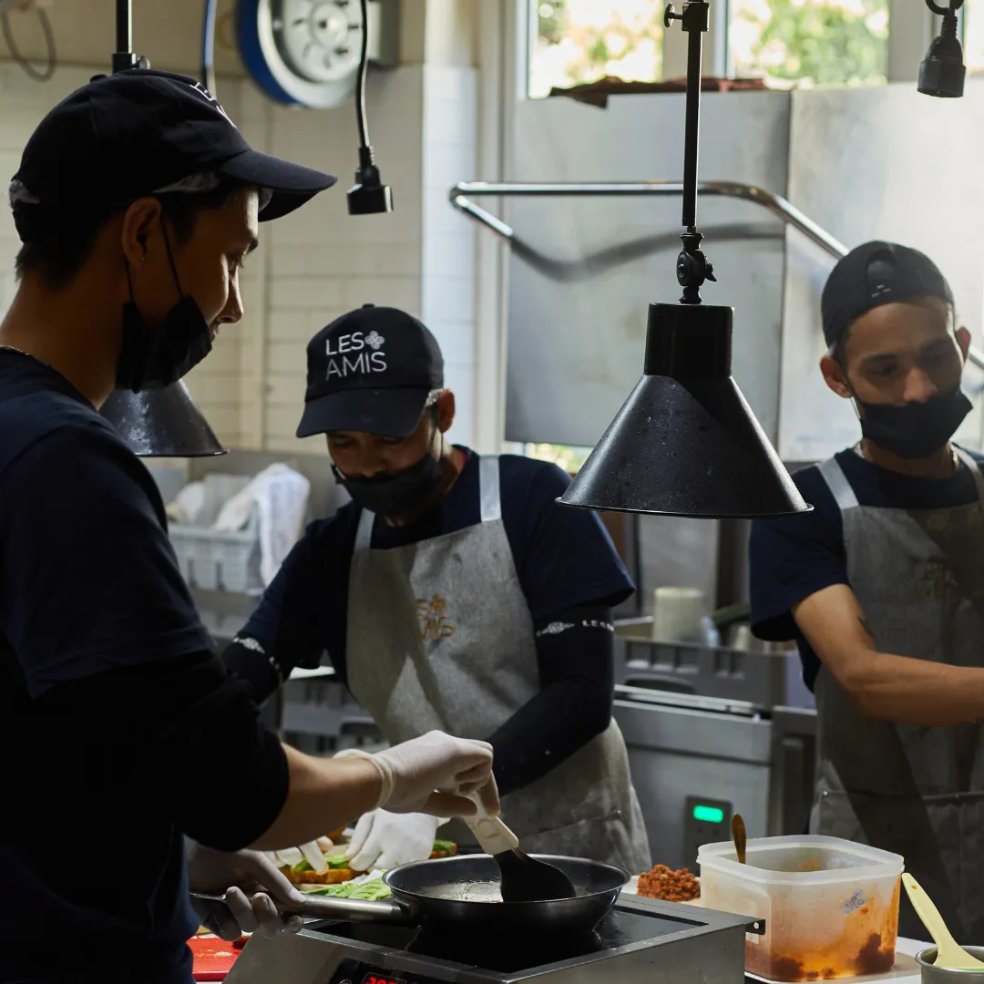 The Les Amis kitchen team at work under the pass lights